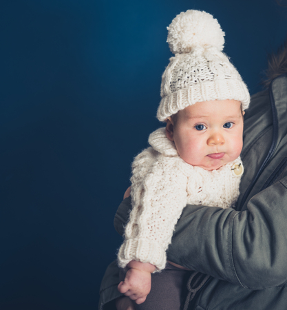 A young baby wearing winter clothesの写真素材