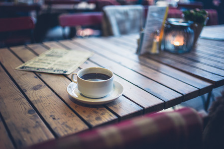 A cup of coffee on a table in a cafe outsideの写真素材