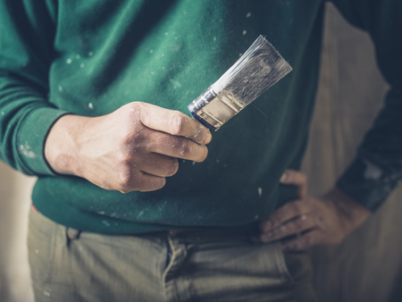 A painter is holding a paintbrushの写真素材