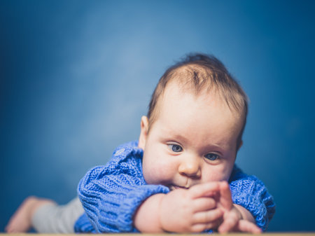 A happy little baby is exploring and learning to crawl