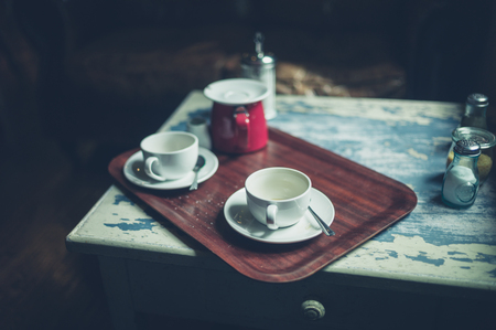 Two empty cups of coffee on a table in a cafeの写真素材