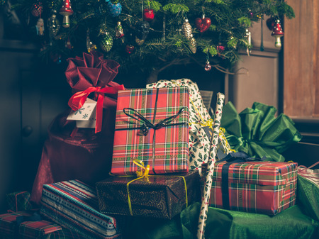 A christmas tree with a bunch of presents underneathの写真素材