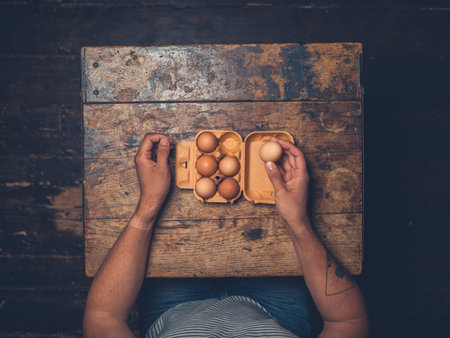 Overhead shot of man sitting at table with eggs