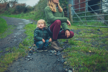 A little toddler and his mother are on a country roadの写真素材