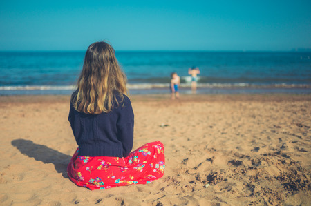 A young woman is relaxing on the beachの写真素材