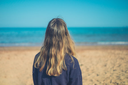 A young woman is relaxing on the beach