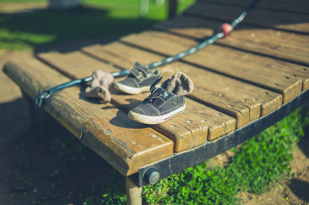A toddler's shoes abandoned on the play equipment in the playgroundの写真素材