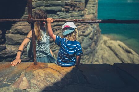 A mother and her little toddler are exploring the river in a small townの写真素材