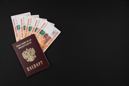 Russian passport and Russian currency close-up lying on a black backgroundの写真素材