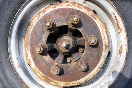 an old rusty disc with rusty nuts and a worn tireの写真素材