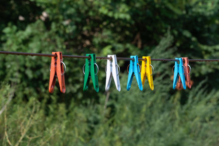 plastic clothespins for drying clothes on a ropeの写真素材