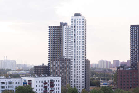 construction of large new houses next to old housesの写真素材