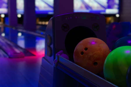 colorful bowling balls on a stand in a bowling clubの写真素材