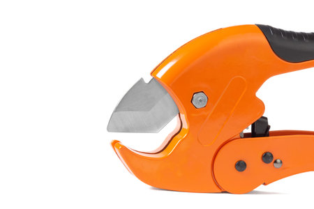 orange scissors for cutting propylene pipes insulated on a white backgroundの写真素材