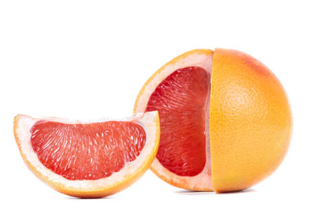 ripe grapefruit and its slices isolated on a white backgroundの写真素材
