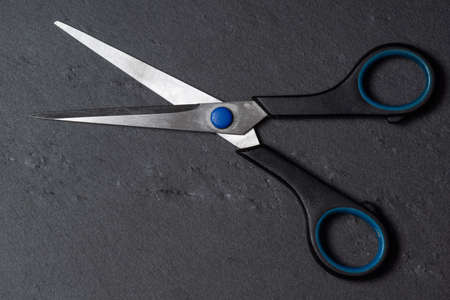 open old scissors on a black rough backgroundの写真素材