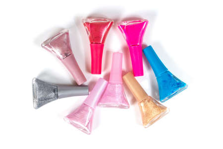 a set of nail polish of different colors in glass bottles isolated on a white backgroundの写真素材