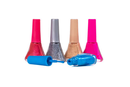 a set of nail polish of different colors in glass bottles isolated on a white backgroundの写真素材
