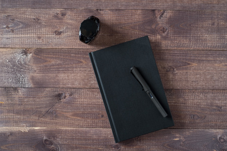 Fountain Pen, Notebook, Ink on wooden tableの写真素材