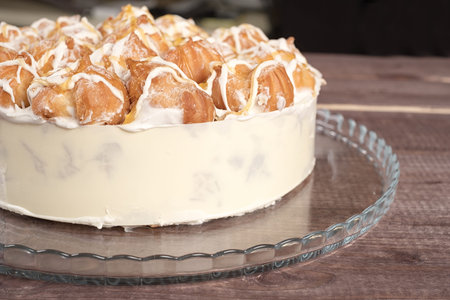 Cake in glass plate on wooden table