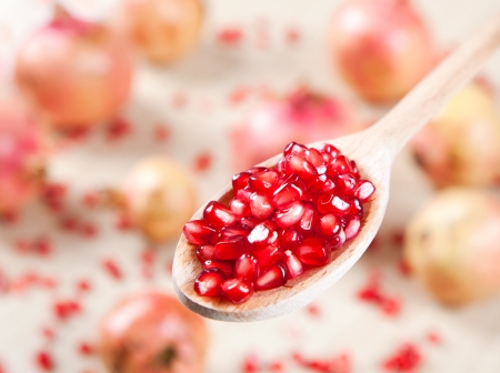 Pomegranate in a wooden spoonの写真素材