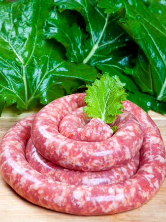 Raw sausage and saladの写真素材