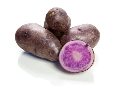 purple potatoes on white backgroundの写真素材