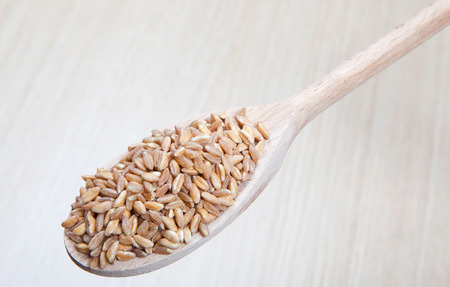 spelt on a wooden spoonの写真素材