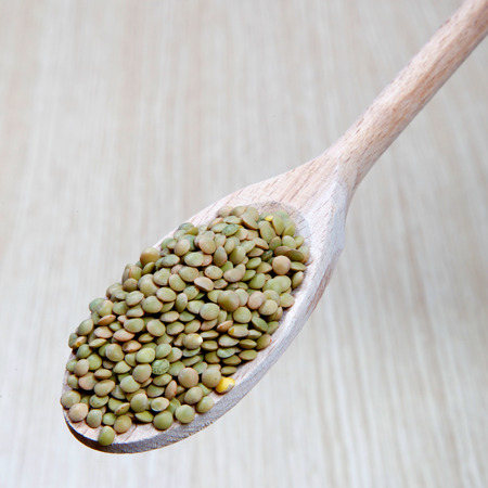 lentils on a wooden spoonの写真素材