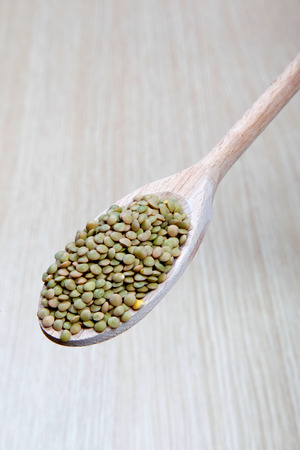 lentils on a wooden spoonの写真素材