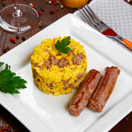 risotto with sausages and saffron in a dishの写真素材