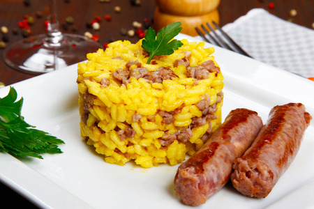 risotto with sausages and saffron in a dishの写真素材