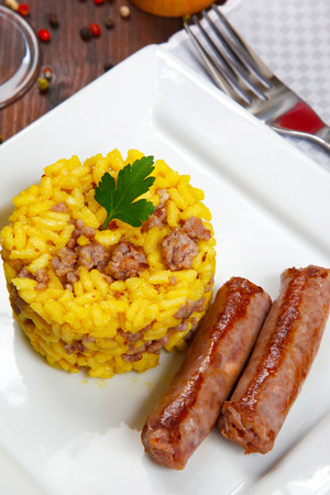 risotto with sausages and saffron in a dishの写真素材