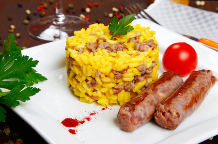 risotto with sausages and saffron in a dishの写真素材