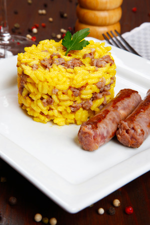 risotto with sausages and saffron in a dishの写真素材