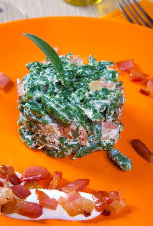 small dumplings with with spinach and bacon in a dishの写真素材