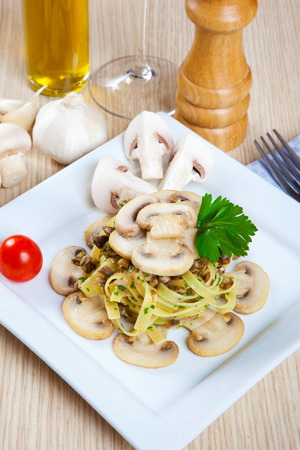 Noodles with mushrooms on a dishの写真素材