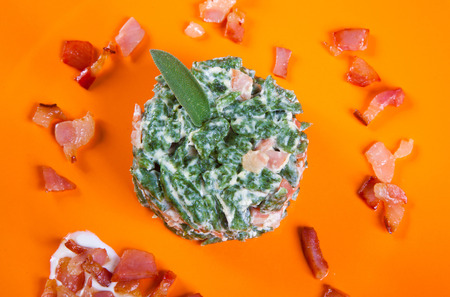 small dumplings with with spinach and bacon in a dishの写真素材