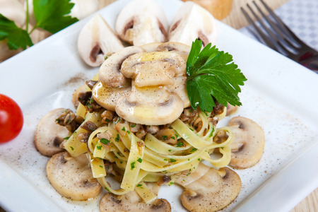 Noodles with mushrooms on a dishの写真素材