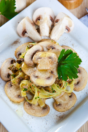 Noodles with mushrooms on a dishの写真素材