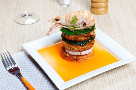 crayfish on a toast with vegetables on a dishの写真素材
