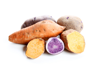 violet potatoes and yam on a white backgroundの写真素材