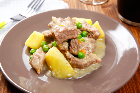 cooked stew with potatoes on a tableの写真素材