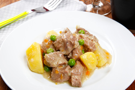cooked stew with potatoes on a tableの写真素材
