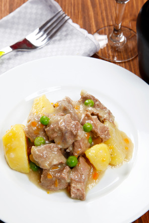 cooked stew with potatoes on a tableの写真素材
