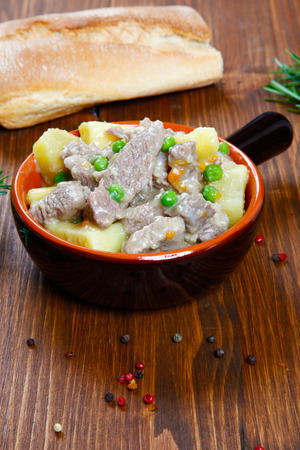 cooked stew with potatoes in a bowlの写真素材