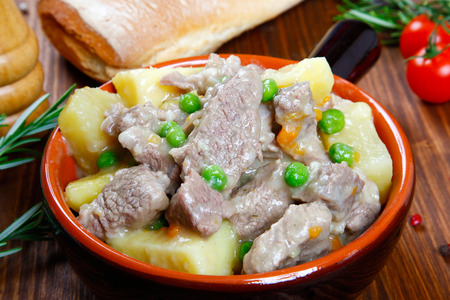 cooked stew with potatoes in a bowlの写真素材