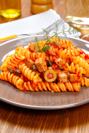 Italian pasta (fusilli) with tuna, olives and capersの写真素材