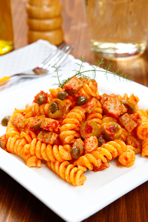 Italian pasta (fusilli) with tuna, olives and capersの写真素材