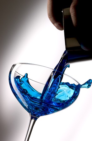 Pour blue liquid into a cocktail glass.の写真素材